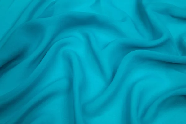 Um delicado tecido de seda faux azul turquesa forrado — Fotografia de Stock