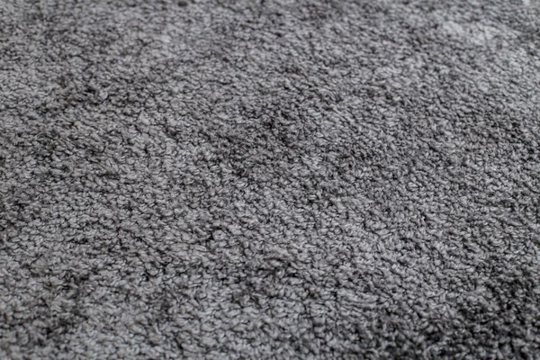 texture of a dark gray soft carpet with a fleecy basis, straight
