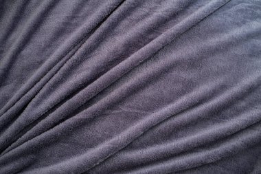 Arkaplanı kıvrımlı mavi yumuşacık halı.