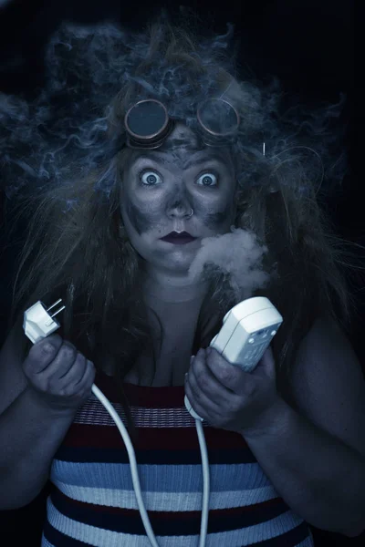 Woman with plug that has exploded with smoke on her head, steampunk glasses and surprise face