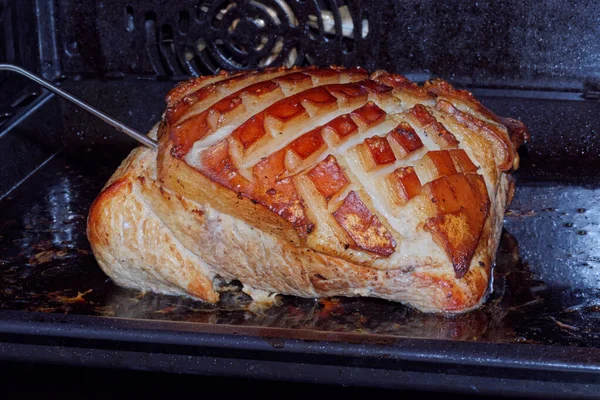 Close-up of roast pork with crackling in the oven — Stock Photo, Image