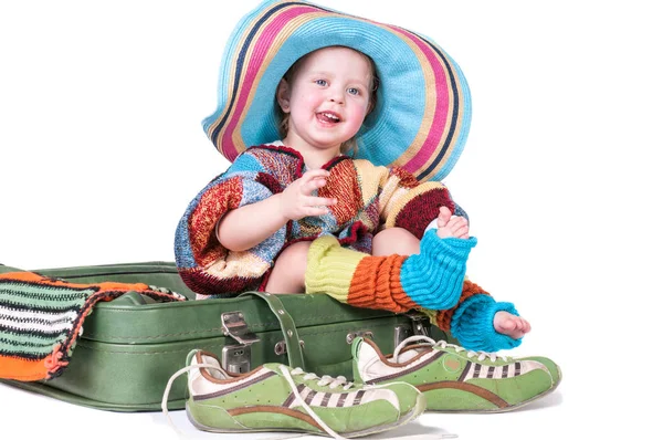 The little girl sitting on a suitcase — Stock Photo, Image