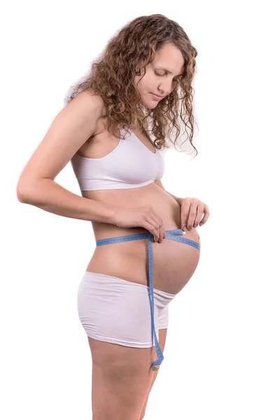 Mujer Embarazada Midiendo Vientre Sobre Fondo Blanco — Foto de Stock