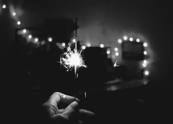 Bengal light in hand Christmas and New Year lights black and white background