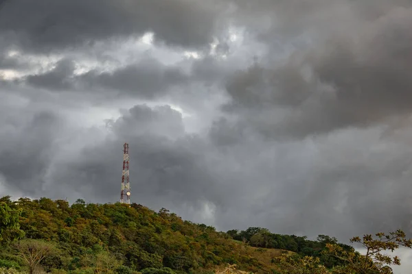Communication tower at top of mountain with clouds — Stock Photo, Image