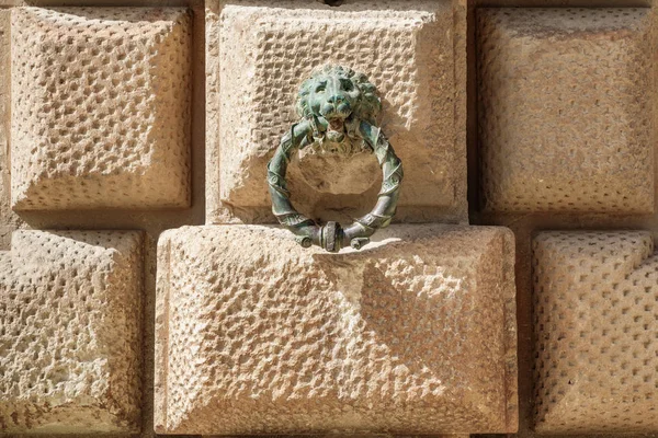 Bronze doorknocker over wall — Stock Photo, Image