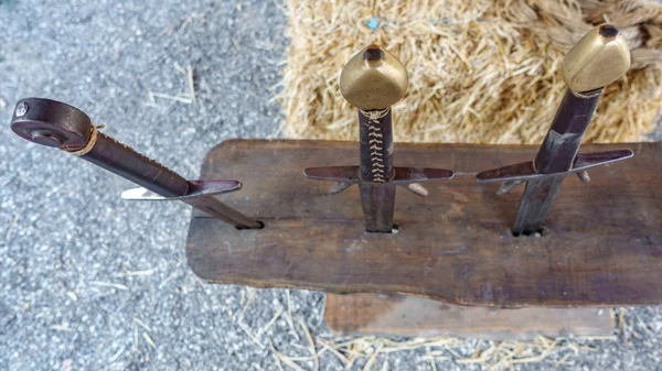 Antique swords over wood and straw — Stock Photo, Image