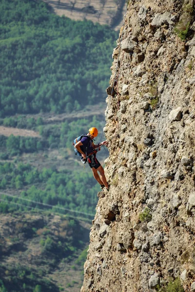 Blurred male climber hanging by a cliff — Stock Photo, Image