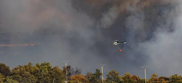 Fire, helicopter and electric towers — Stock Photo, Image