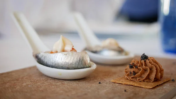 Spanish tapa with anchovy over spoon — Stock Photo, Image