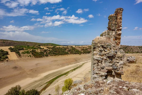 Ruins of castle and drought with dry dam — Stock Photo, Image