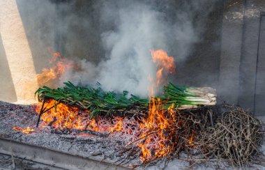 Yangında geleneksel Katalan calsots hazırlanıyor