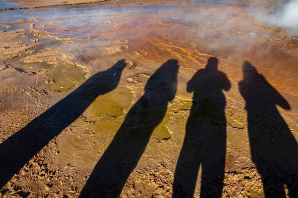 Tourist shadows near geyser with bright colors — Stock Photo, Image