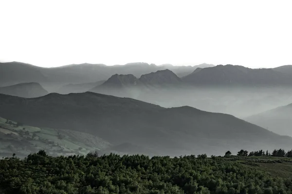 Mist over the mountains with white sky — Stock Photo, Image