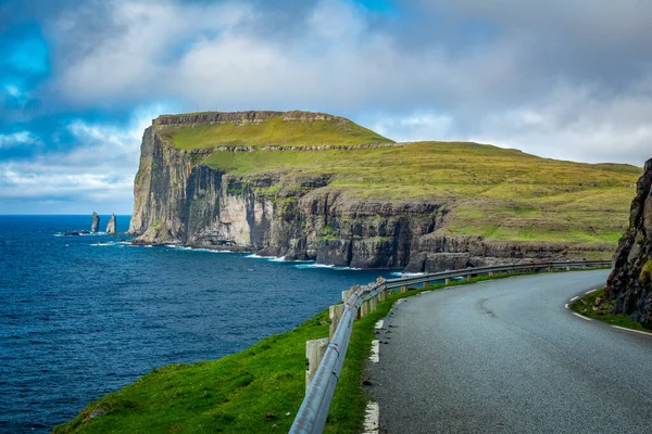 Road and The Giant and the Wich in the north coast of Eysturoy in Faerské ostrovy. — Stock fotografie