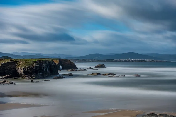 Long exposure in cathedral beach with holes in the rocks — Stock Photo, Image