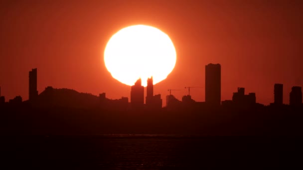 Huge sunset over Benidorm city skyline — Stock Video