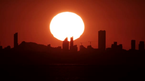 Huge sunset over Benidorm city skyline — Stock Video