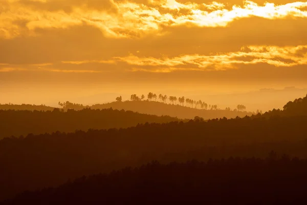 オレンジの空と多くの丘の層で日没 — ストック写真
