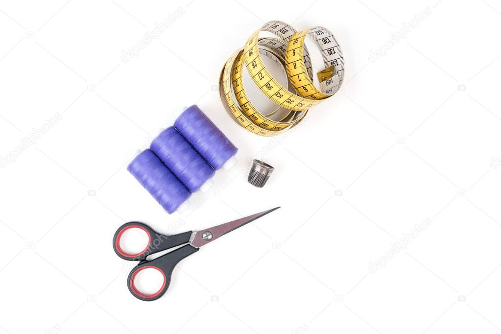 Sewing supplies and tools, three medium purple sewing threads, yellow measuring tape with black numbers, small closed scissors and metal thimble on a white background