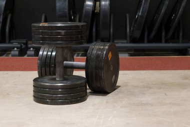 İki eski ve kullanılan spor salonu siyah metal dambıl. Egzersiz ve fitness ekipmanları