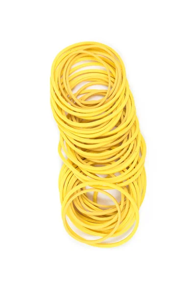 Pile of yellow rubber bands isolated on white background. Packaging supplies and accessory. Thin rubber bands