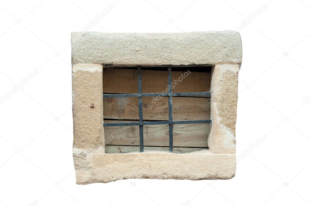 Small stone frame window with black metal bars isolated on white background. Vintage window.