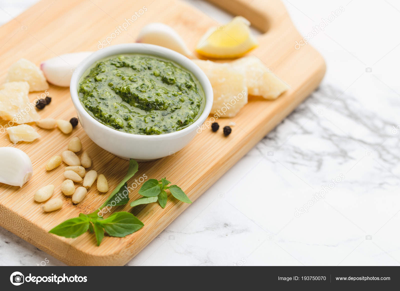On A Marble Table Wooden Cutting Board In Round Cup Green On A Marble Table Wooden Cutting Board In Round Cup Green Pesto Sauce