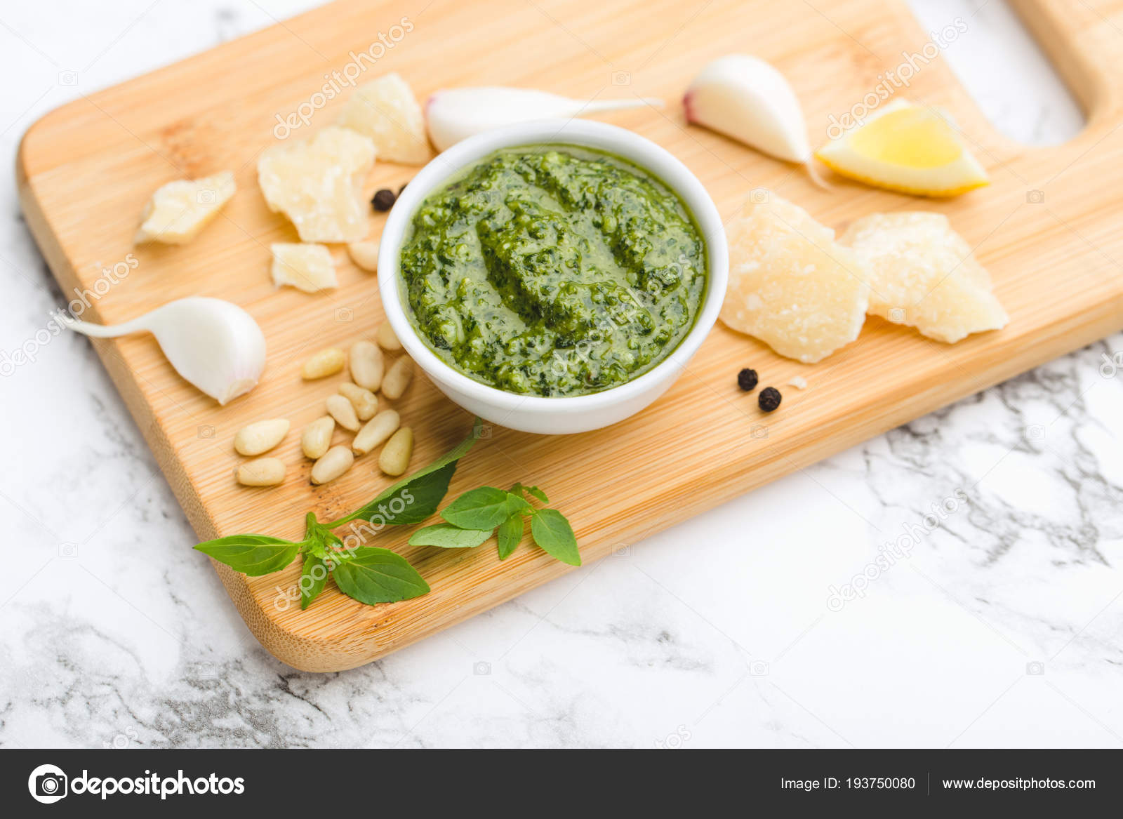 On A Marble Table Wooden Cutting Board In Round Cup Green On A Marble Table Wooden Cutting Board In Round Cup Green Pesto Sauce