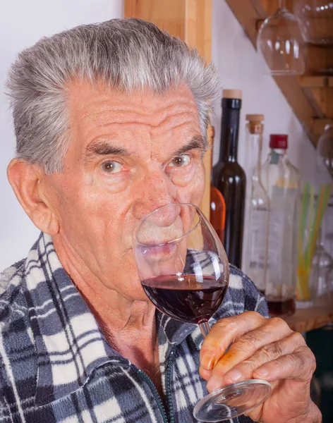 Elderly man with a glass of wine — Stock Photo, Image