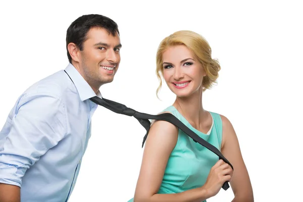 Woman pulling man for his tie — Stock Photo, Image