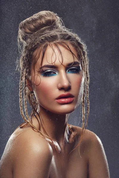 Menina bonita com maquiagem azul em gotas de água — Fotografia de Stock