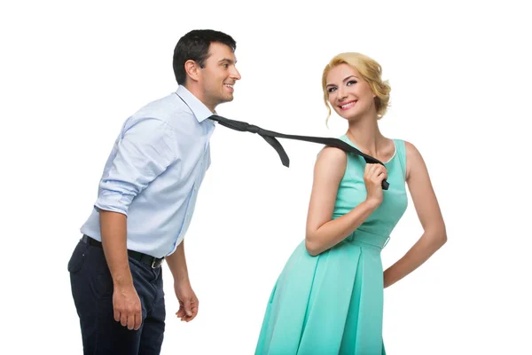 Woman pulling man for his tie — Stock Photo, Image