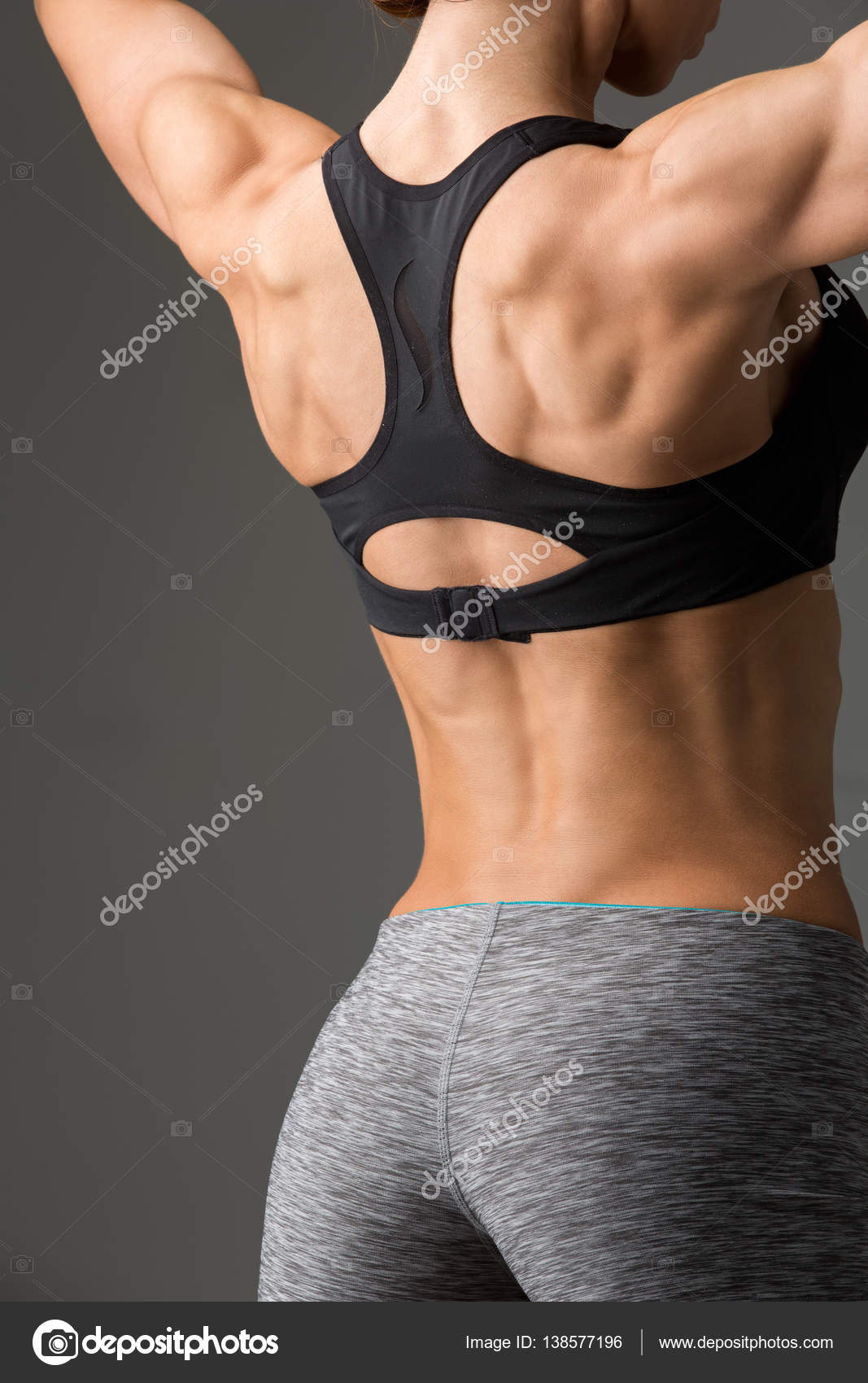 Sporty girl back with muscles Stock Photo by ©Svetography 138577196