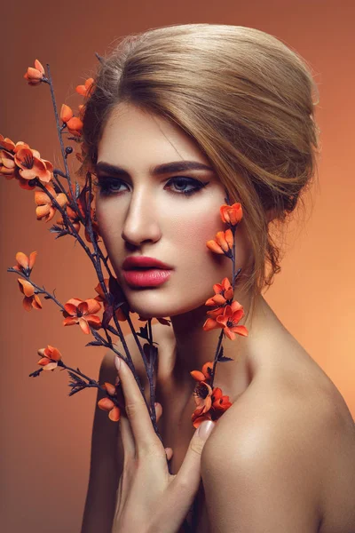 Beautiful girl with sakura branch — Stock Photo, Image