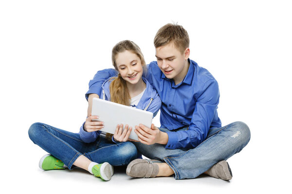 Teen age boy and girl with tablet
