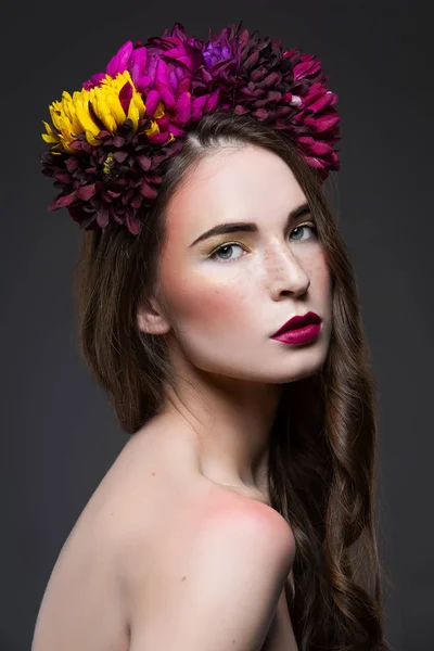 Menina bonita com flores na cabeça — Fotografia de Stock