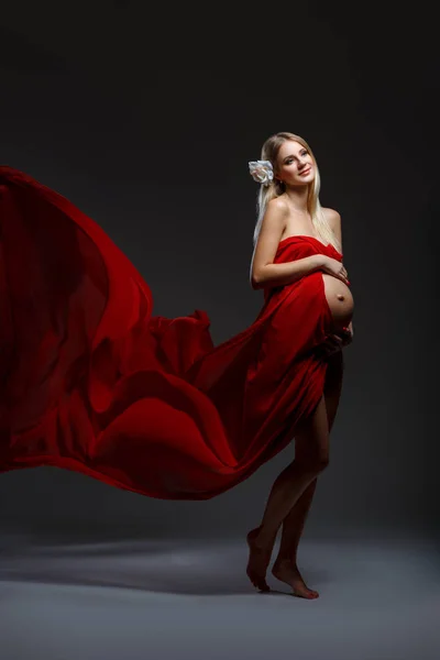 Pregnant girl in red dress — Stock Photo, Image