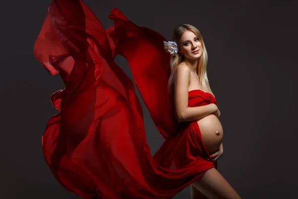 Pregnant girl in red dress — Stock Photo, Image