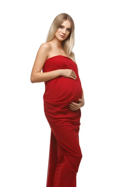 Těhotná dívka v červených šatech — Stock fotografie