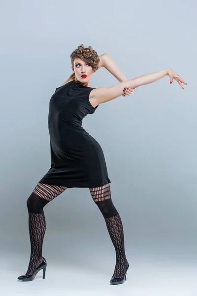 Woman posing in small black dress — Stock Photo, Image