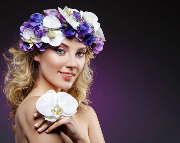 Beautiful blond girl with flowers — Stock Photo, Image