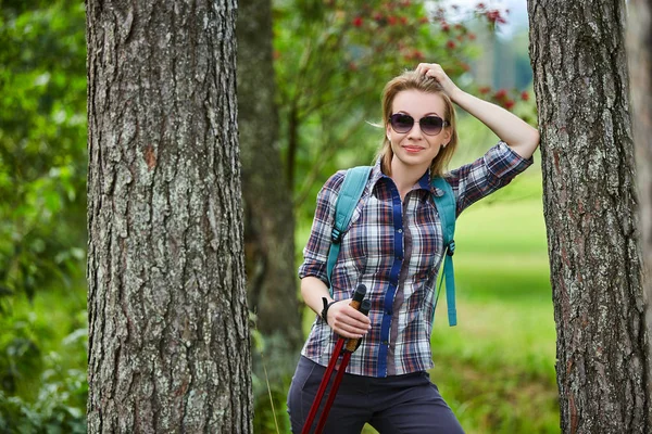 young woman with nordic walk pols