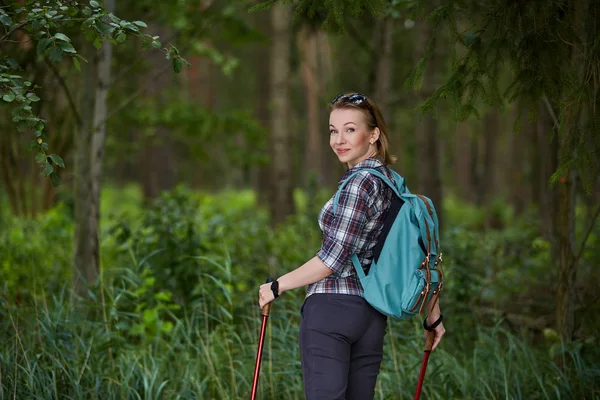 young woman with nordic walk pols