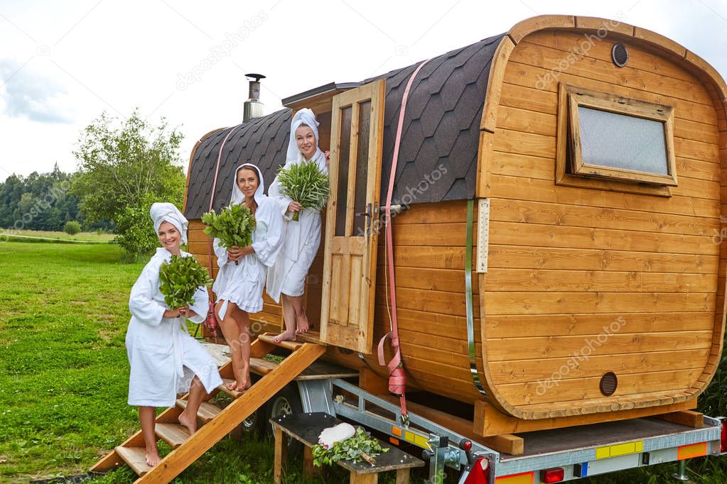 three girls relaxing outside sauna