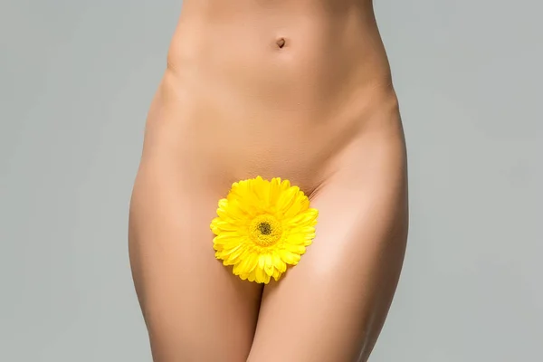 Beautiful woman naked body with flower between legs — Stock Photo, Image