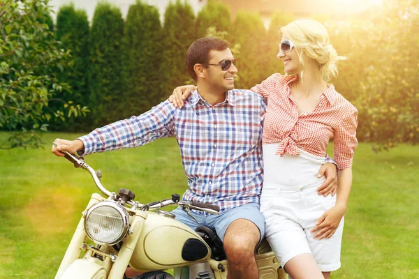 beautiful couple on retro motorbike