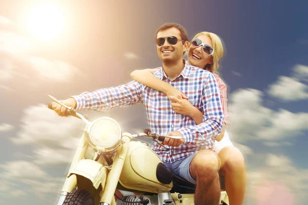 beautiful couple on retro motorbike