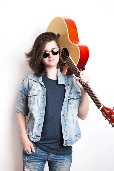 Portrait of handsome teenager holding his guitar on shoulders — Stock Photo, Image