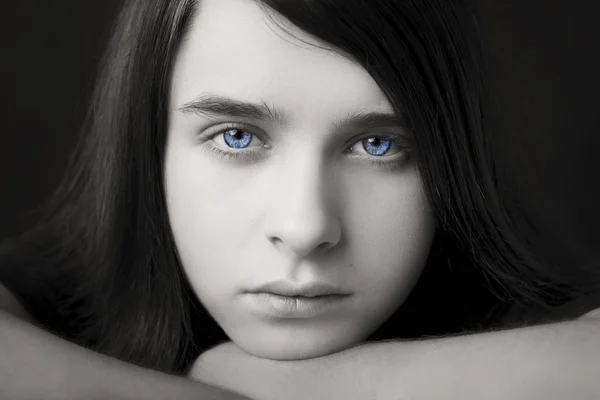 Un retrato de un guapo ojos azules adolescente sobre fondo oscuro — Foto de Stock